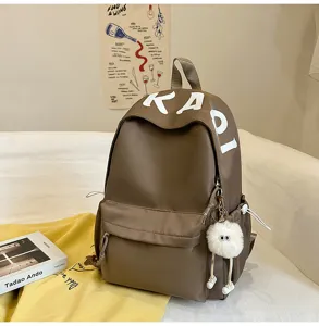 Detailed view of the brown Japanese style casual large capacity backpack with cute doll.