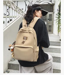Casual campus minimalist large capacity beige backpack with cute bear pendant and side pockets.