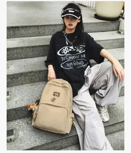Casual campus backpack large capacity solid color school bag for students and daily commuting wear.