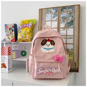 Pink cute student backpack detail showing adorable dog embroidery, front pocket and bow.