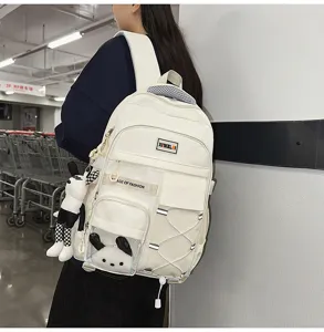 White canvas school backpack with large capacity and cute bunny pendant for students.