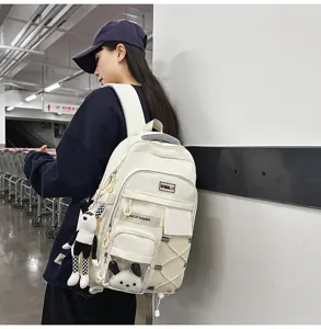 Large capacity ergonomic white school backpack for students, featuring cute pendant detail.