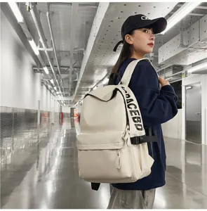 Detailed view of the white PU leather waterproof backpack showing side strap details.