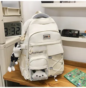 Large capacity white student school backpack with cute plush bear pendant for teens and kids.