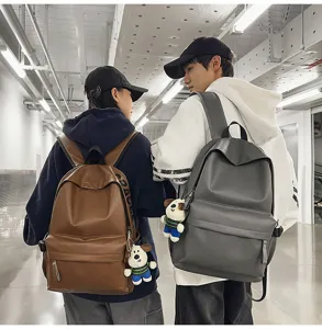 Stylish PU leather casual backpack for women and men, waterproof college school bag.