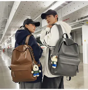 Close-up detail of stylish soft PU leather casual backpacks with cute dog plush pendants.