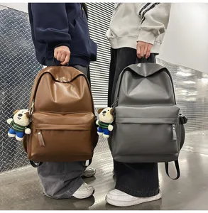 Detailed view of casual PU leather backpack with cute dog pendant and front pocket design.
