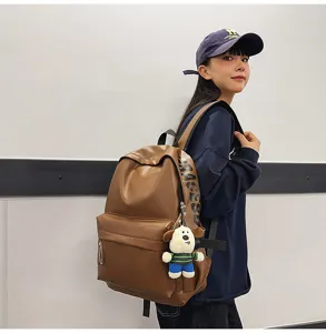 Brown PU leather waterproof backpack for women, stylish college student casual school bag.