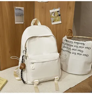 Detailed view of the minimalist white backpack in a cozy room setting with straps and pockets.