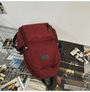 Casual canvas backpack in dark red, large capacity school bag for daily use and campus style.
