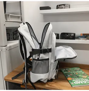 Large capacity school backpack in white with side mesh pockets and buckle straps detail view.