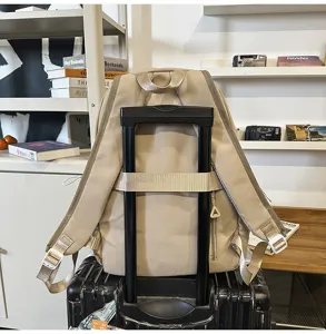 Beige travel backpack with luggage strap, large capacity casual school bookbag for daily use.