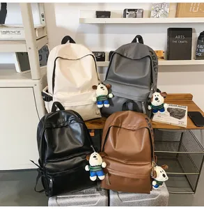 PU leather waterproof casual backpack for women and students with cute dog pendant and pockets.
