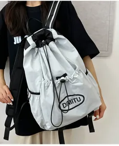 Detail view of lightweight drawstring backpack with front pocket and adjustable straps.