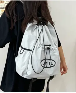 Lightweight nylon drawstring backpack with black cords and front pocket detail for outdoor sports.
