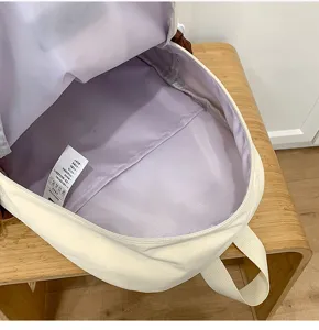 Detailed view of the open casual backpack interior showcasing spacious lining and care label.