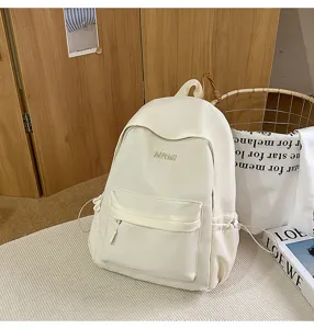 Detail view of the casual white campus backpack showcasing front pocket and side drawstring features.