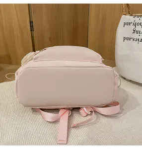 Pink casual school backpack detail view, light canvas daily travel rucksack for students and teens.