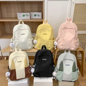 Casual multi-color school backpack for women, large capacity waterproof travel daypack with cute pendant.