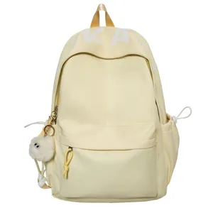 Casual yellow backpack for women students, large capacity school bag with cute furry keychain.