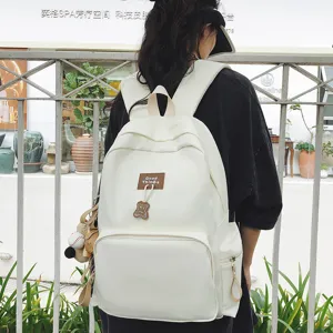 Casual canvas school backpack with large capacity, minimalist design for students and youth.