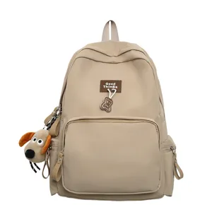 Casual campus large capacity solid color backpack with cute plush dog pendant and zipper pockets.