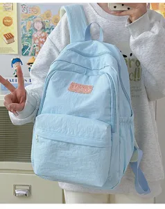Light blue minimalist backpack detail shot, fresh style daily school bag for students and teens.