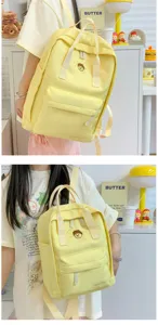 Casual yellow school backpack with cute front pocket, trendy canvas bag for daily student use.