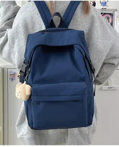Detail shot of the minimalist casual nylon backpack in dark blue, showing daily wearing style.
