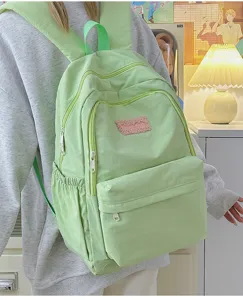 Light green canvas backpack for school girls, spacious multi-pocket design, aesthetic daily bag.