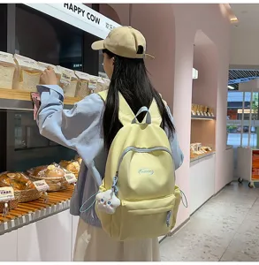 Mochila de lona amarilla elegante para estudiantes, bolso casual lindo con bolsillo delantero.