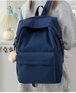 Casual solid color nylon backpack for women, stylish daily school bookbag with pockets.