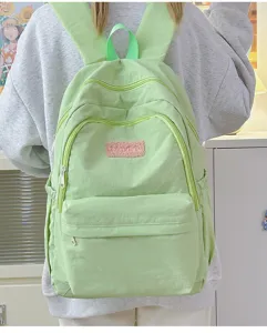 Lightweight minimalist backpack for women, casual school bag with multiple zipper pockets.