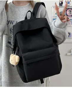 Casual black nylon backpack for women, stylish daily school bag with cute bear pendant.
