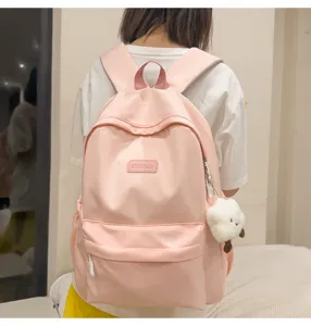 Cute pink school backpack for teens and students, casual daily casual daypack with pendant.