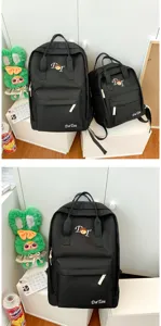 Black campus style canvas backpack with front pocket, versatile daily school bag for students.