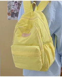 Lightweight yellow casual backpack for women, stylish school bag with multiple pockets.