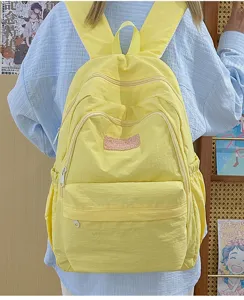 Casual yellow nylon backpack with multi-layer zipper pockets and cute front plush patch.