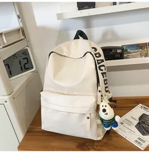 White PU leather waterproof school bag for women, simple computer backpack detail shot.