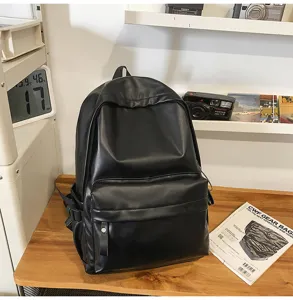 Black PU leather backpack detail view, simple style daily school bag with front pocket.