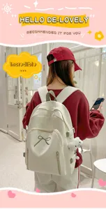 Detail view of cute student backpack with green bow and cloud pendant worn by model.