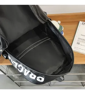 Black PU leather backpack detail interior showing soft material and spacious main compartment.