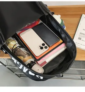 Detail view of black PU leather backpack interior showcasing large capacity storage for daily essentials.