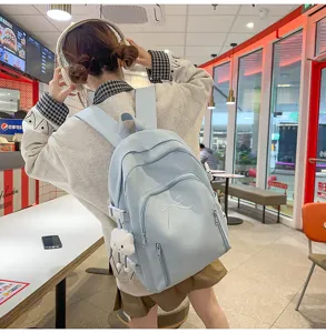 Cute Japanese style student backpack with bow embroidery and cloud pendant, large capacity.