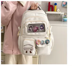 Cute Japanese style white canvas backpack with multi pockets and anime badges for students.