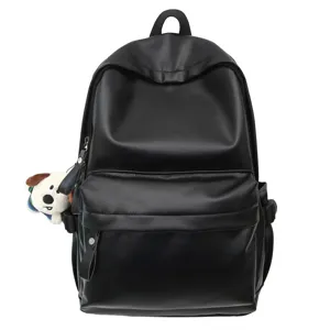 Black PU leather backpack for women, minimalist daily school bag with cute puppy plush charm.