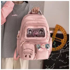 Pink student backpack detail view, large capacity school bag with clear window and cute badges.