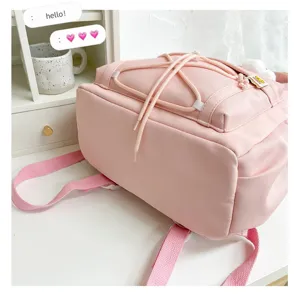 Pink canvas backpack for school girls, minimalist casual daypack with drawstring design.