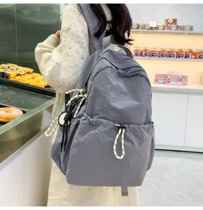 Solid color nylon backpack for women, large capacity school bag and lightweight travel daypack.