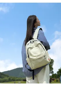 Detailed view of the lightweight beige canvas backpack in a casual Korean style for students.